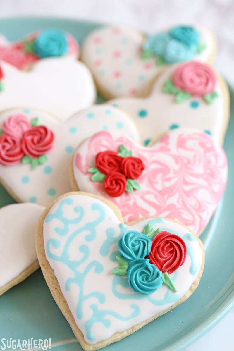 Valentine's Day Sugar Cookies - sugar cookies with swirled design and piped rosettes on top | From SugarHero.com