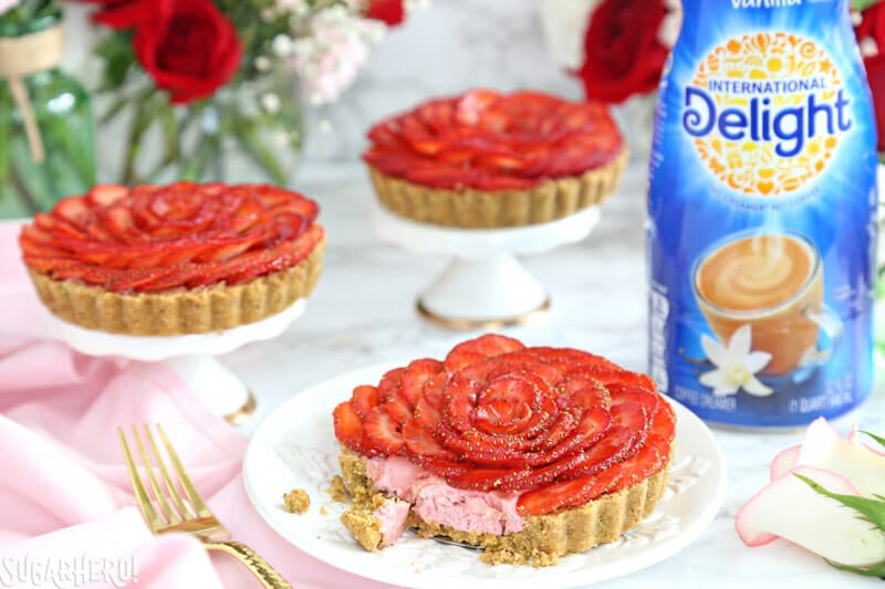 Strawberry Rose Tarts - three tarts, with bites taken out of one tart | From SugarHero.com