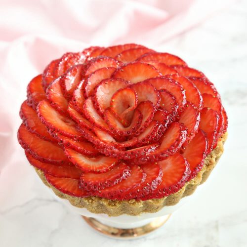 Close-up of Strawberry Rose Tart with a pink napkin in the background.