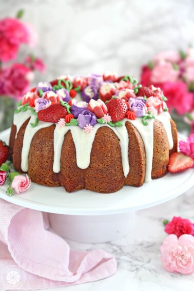 A Strawberry Swirl Bundt Cake on a white cake plate.