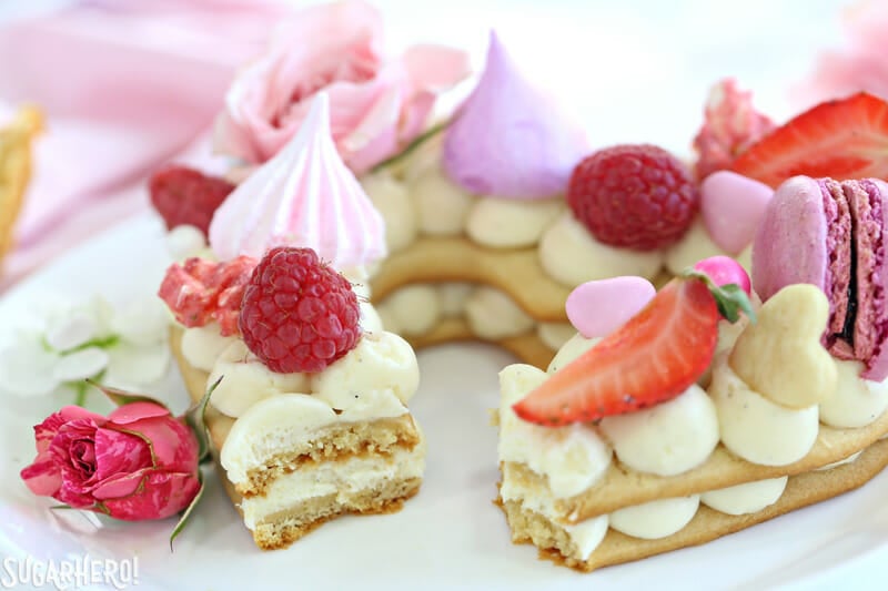 Trendy Cream Tarts are all the rage! Also known as cream biscuits or cream cakes, you can cut them into letters, numbers, or shapes, and decorate them with fruits, flowers, and candies. | From SugarHero.com Trendy Cream Tarts - close-up photo showing the texture of a cream biscuit with a bite taken out of it | From SugarHero.com