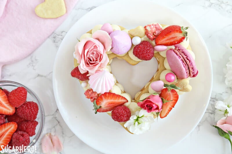 Trendy Cream Tarts are all the rage! Also known as cream biscuits or cream cakes, you can cut them into letters, numbers, or shapes, and decorate them with fruits, flowers, and candies. | From SugarHero.com Trendy Cream Tarts - overhead shot of a single heart-shaped cream biscuit | From SugarHero.com