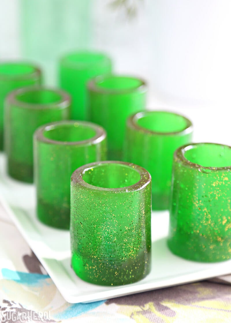 DIY Candy Shot Glasses - now you can make your own edible shot glasses out of sugar! Fill them with your favorite drink, whipped cream, mousse, or whatever else you'd like! | From SugarHero.com DIY Candy Shot Glasses - group of candy glasses lined up on a table | From SugarHero.com