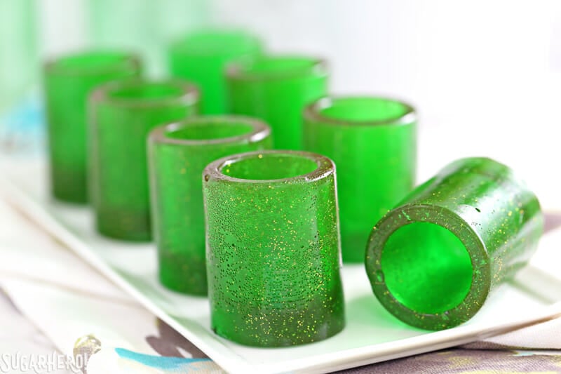 DIY Candy Shot Glasses - group of candy shot glasses with one glass lying on its side | From SugarHero.com