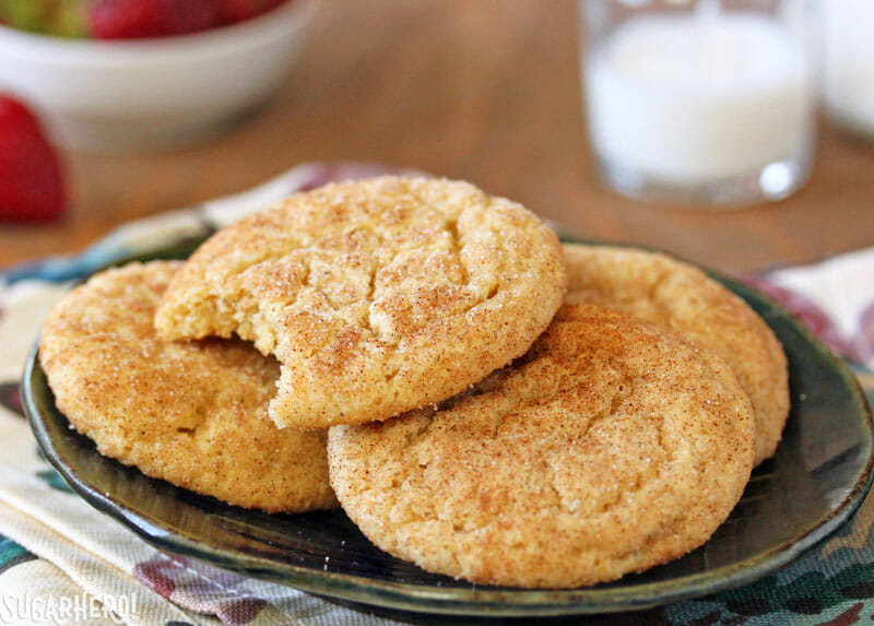 Snickerdoodle Cookies - a stack of snickerdoodle cookies with a bite taken from the top cookie | From SugarHero.com