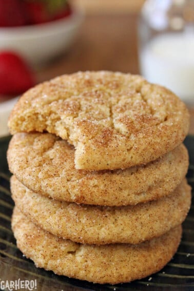 4 Snickerdoodles in a tall stack with a bite removed from the top cookie.
