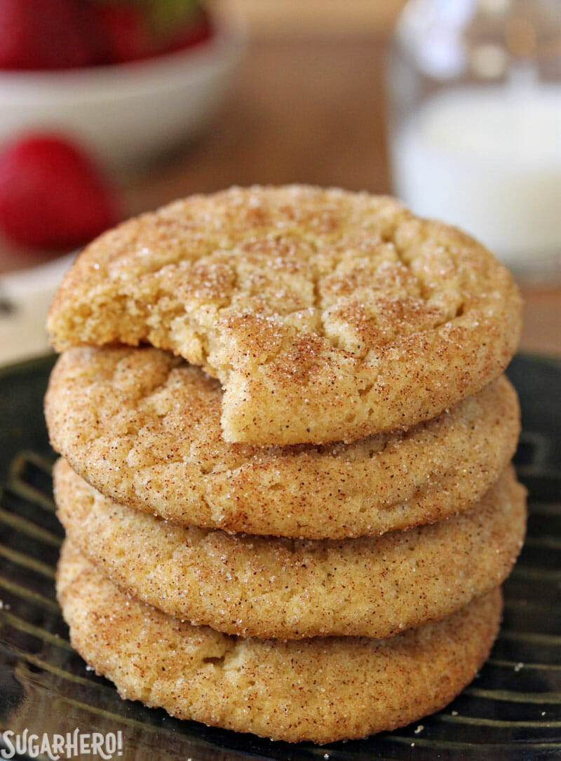 Snickerdoodle Cookies - a stack of cookies on a small plate with a bite taken from the top cookie | From SugarHero.com