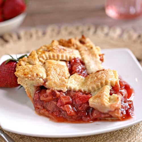 Overhead shot of a baked strawberry rhubarb pie with a lattice crust top.