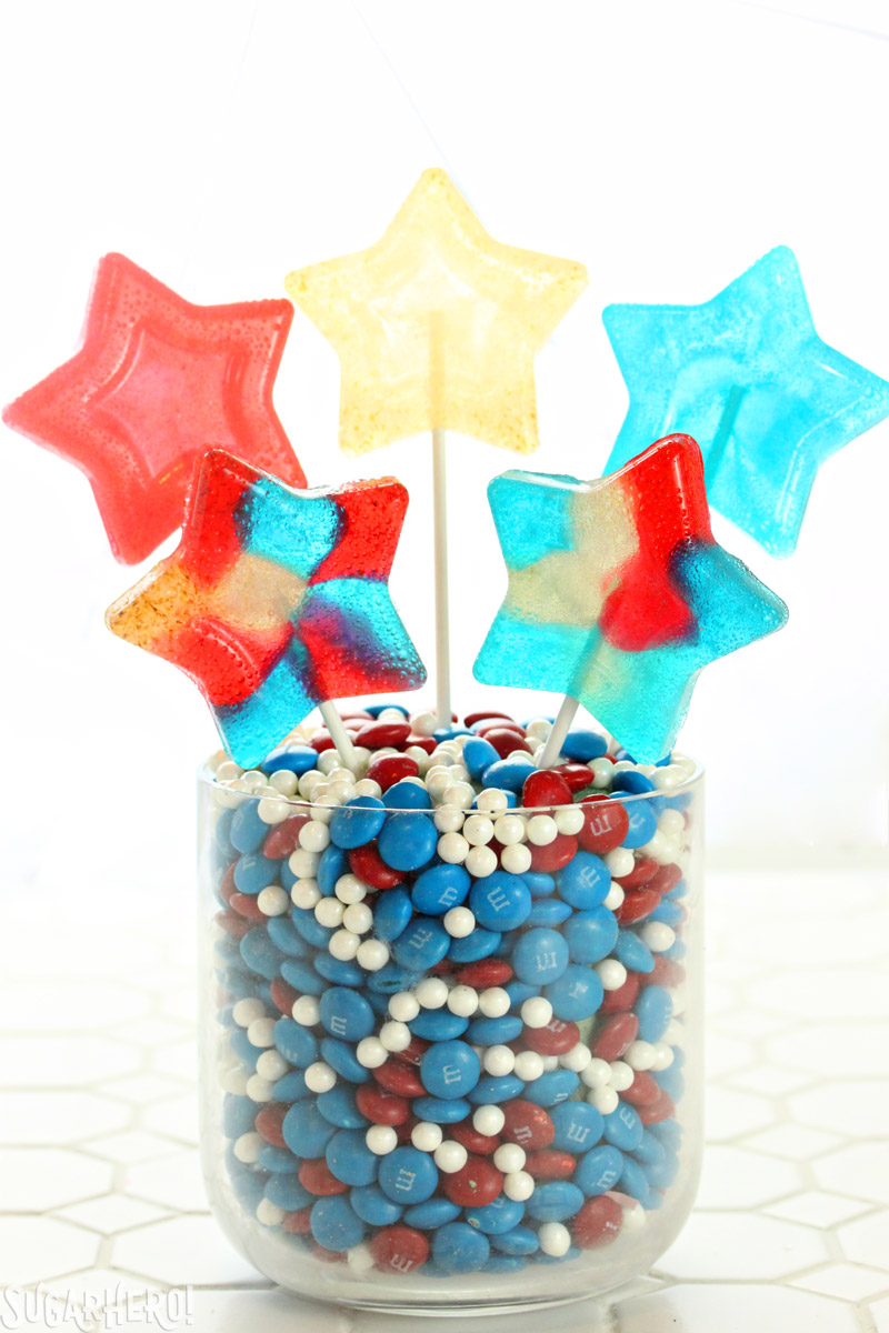 Easy Homemade Lollipops - red, white, and blue star-shaped homemade lollipops in candy vase | From SugarHero.com