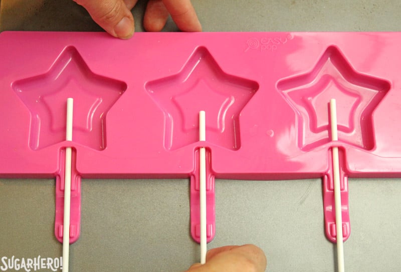 Easy Homemade Lollipops - star-shaped silicone candy mold with lollipop sticks | From SugarHero.com
