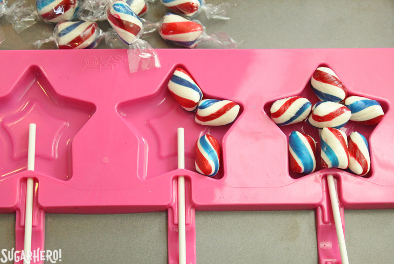 Easy Homemade Lollipops - putting swirled mint candies into a star-shaped silicone lollipop mold | From SugarHero.com