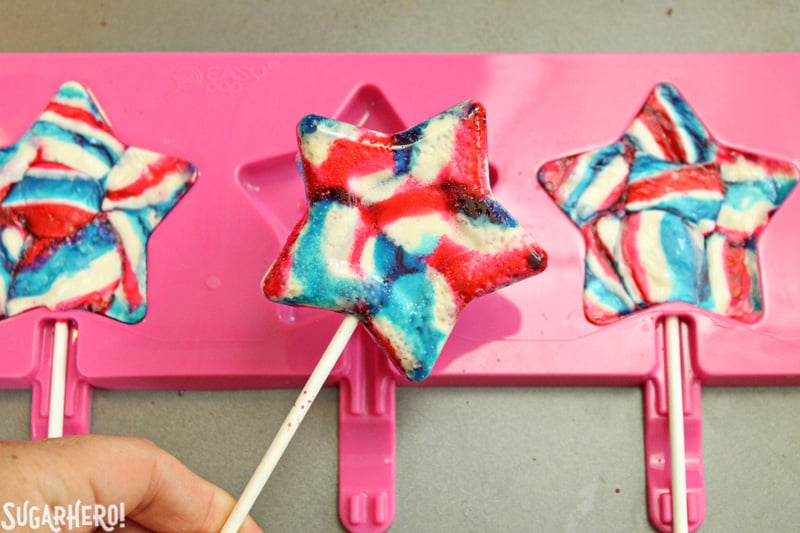 Easy Homemade Lollipops - swirled red, white, and blue star-shaped lollipop | From SugarHero.com