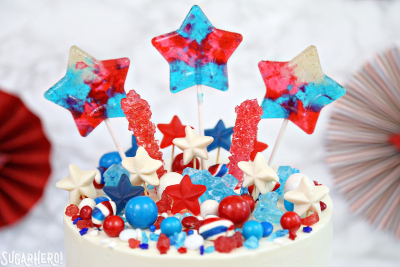 Fourth of July Layer Cake - close-up of colorful candy assortment on top of tall layer cake | From SugarHero.com 