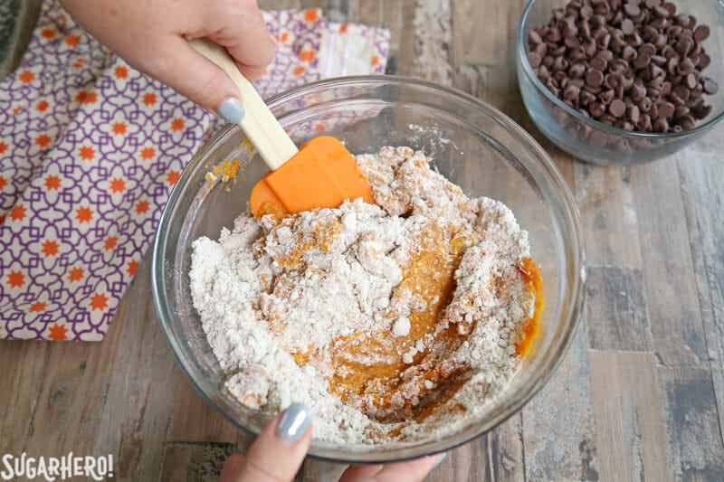 3-Ingredient Pumpkin Chocolate Chip Cookies - stirring together the cake mix and pumpkin puree | From SugarHero.com