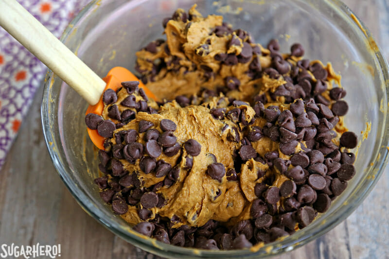 3-Ingredient Pumpkin Chocolate Chip Cookies - adding the chocolate chips to the pumpkin cookie dough | From SugarHero.com