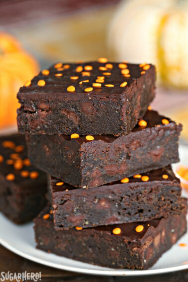 A stack of 4 2-Ingredient Pumpkin Brownies on a small white plate.