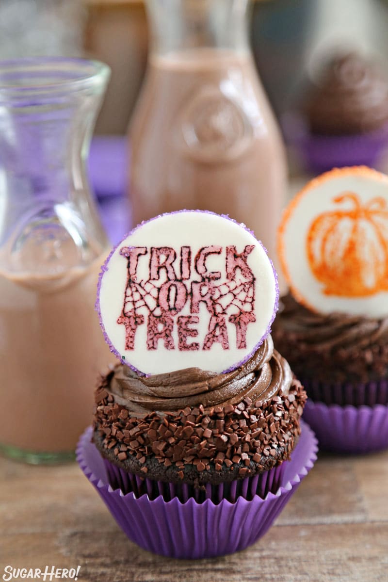 Stamped Halloween Cupcakes - chocolate cupcake with chocolate frosting and a "Trick or Treat" fondant plaque | From SugarHero.com