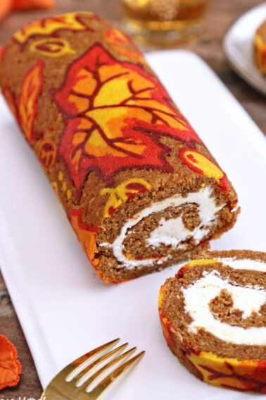 Patterned pumpkin roll with slices removed.