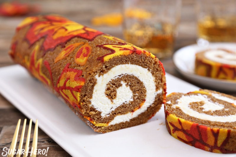 A straight shot of the pumpkin roll displaying the filling inside the roll. 