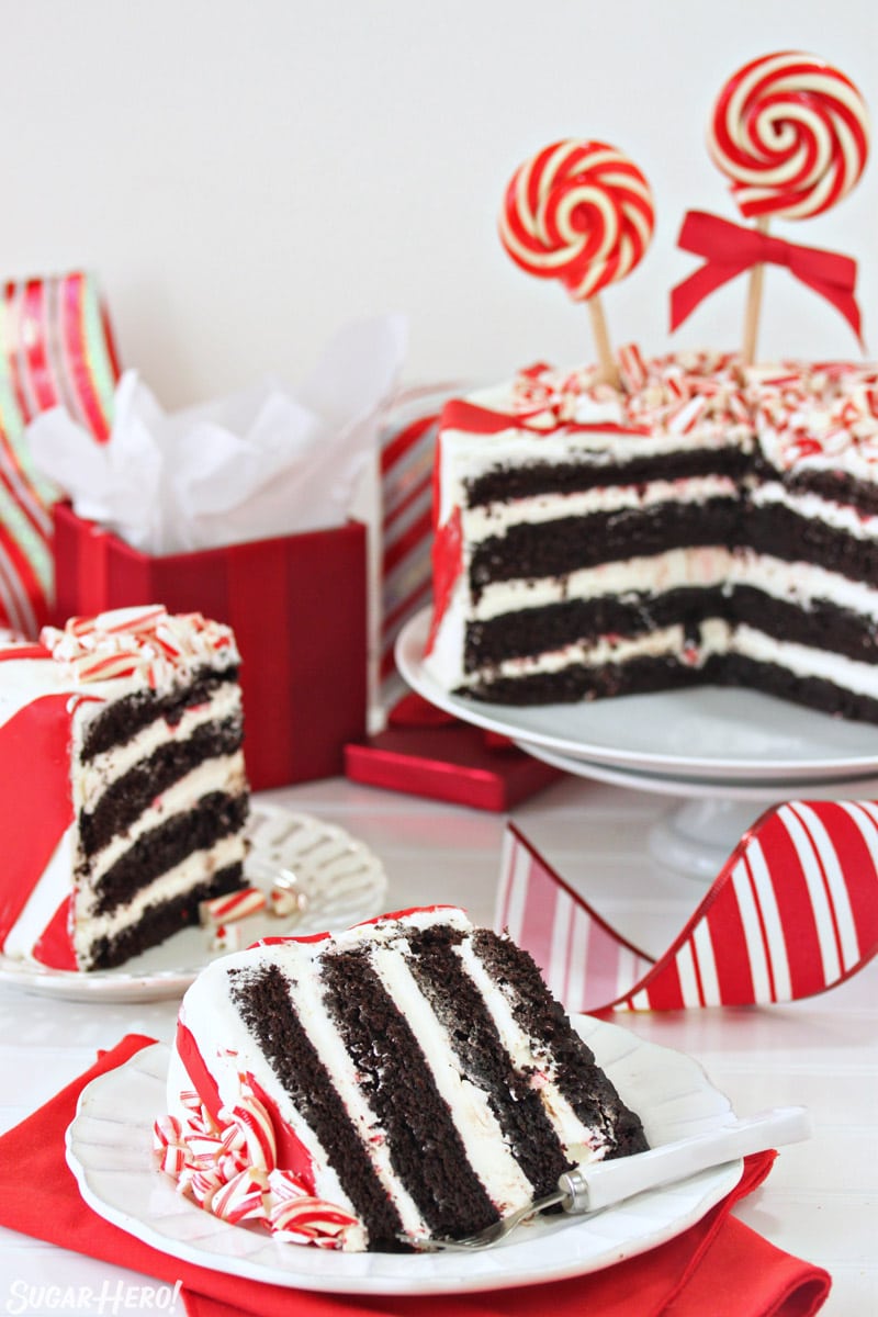 Candy Cane Chocolate Cake - cake cut open with two slices of cake next to it | From SugarHero.com