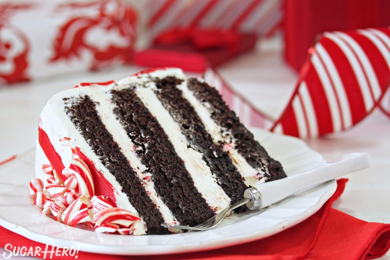 Candy Cane Chocolate Cake - close-up on slice of cake on a white plate | From SugarHero.com