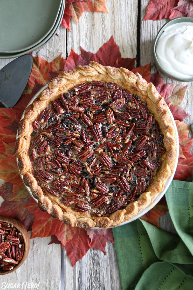 Deep Dish Pecan Pie - a gloriously gooey pie, packed with toasted pecans and chunks of chocolate. For serious pie lovers only! | From SugarHero.com Deep Dish Pecan Pie - overhead vertical picture of a deep dish pecan pie | From SugarHero.com