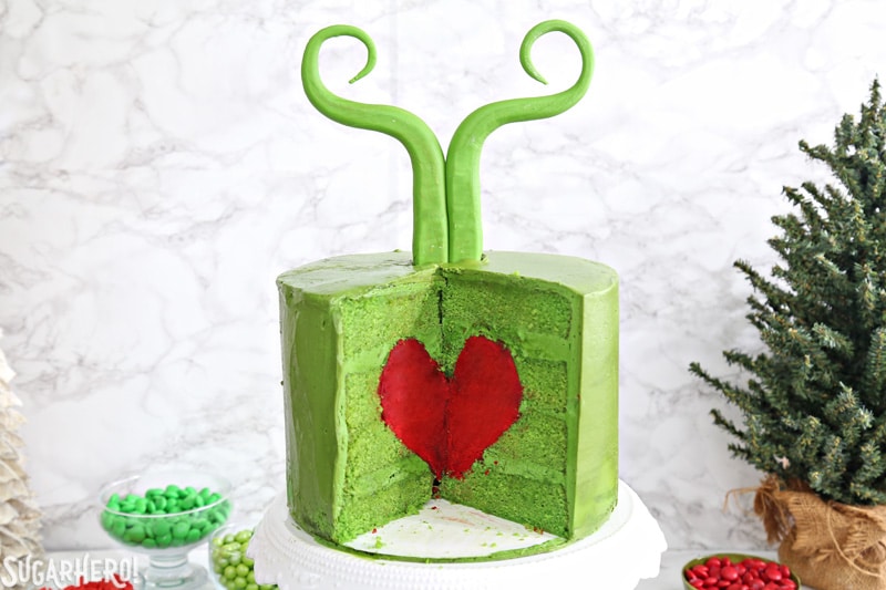 Grinch Cake - inside of the green Grinch cake, containing a bright red cake heart | From SugarHero.com
