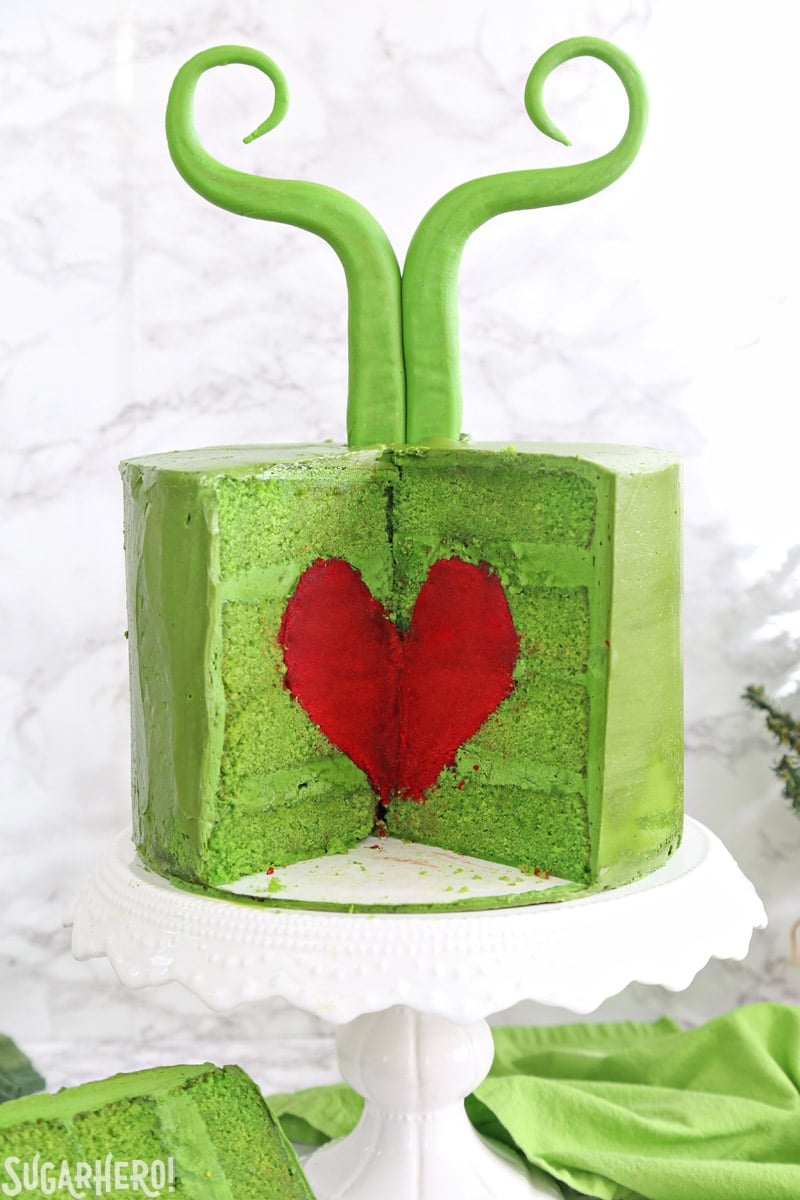 Grinch Cake - inside of the green Grinch cake, containing a bright red cake heart | From SugarHero.com