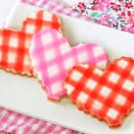 3 Brown Butter Heart Cookies with a gingham design on a white plate.