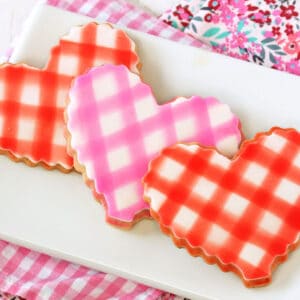 3 Brown Butter Heart Cookies with a gingham design on a white plate.