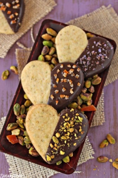 3 Pistachio Shortbread Cookies on a small tray with pistachios.