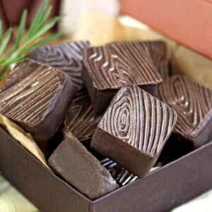 A box of Rosemary Raspberry Truffles with an embossed wood grain pattern.