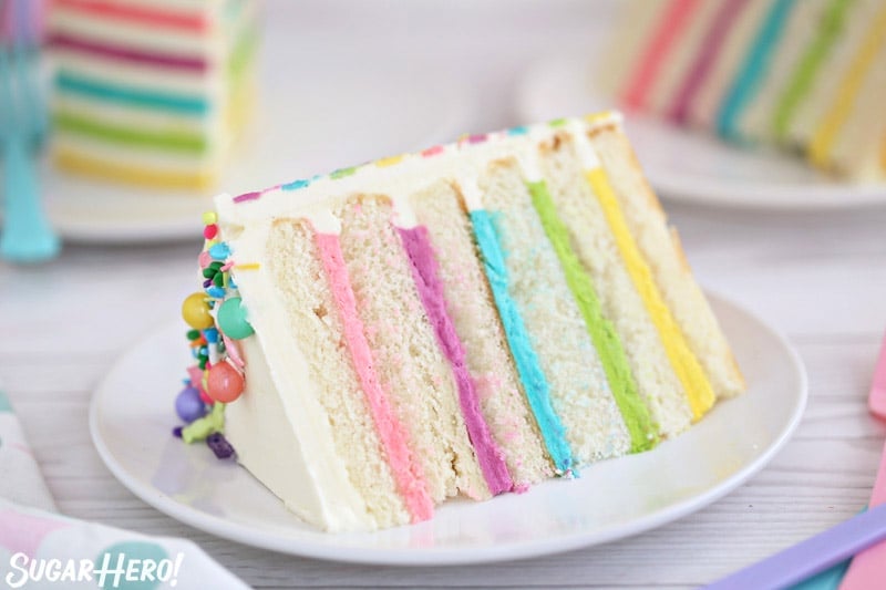 Close-up of a slice of white cake with multi-colored buttercream between the cake layers.