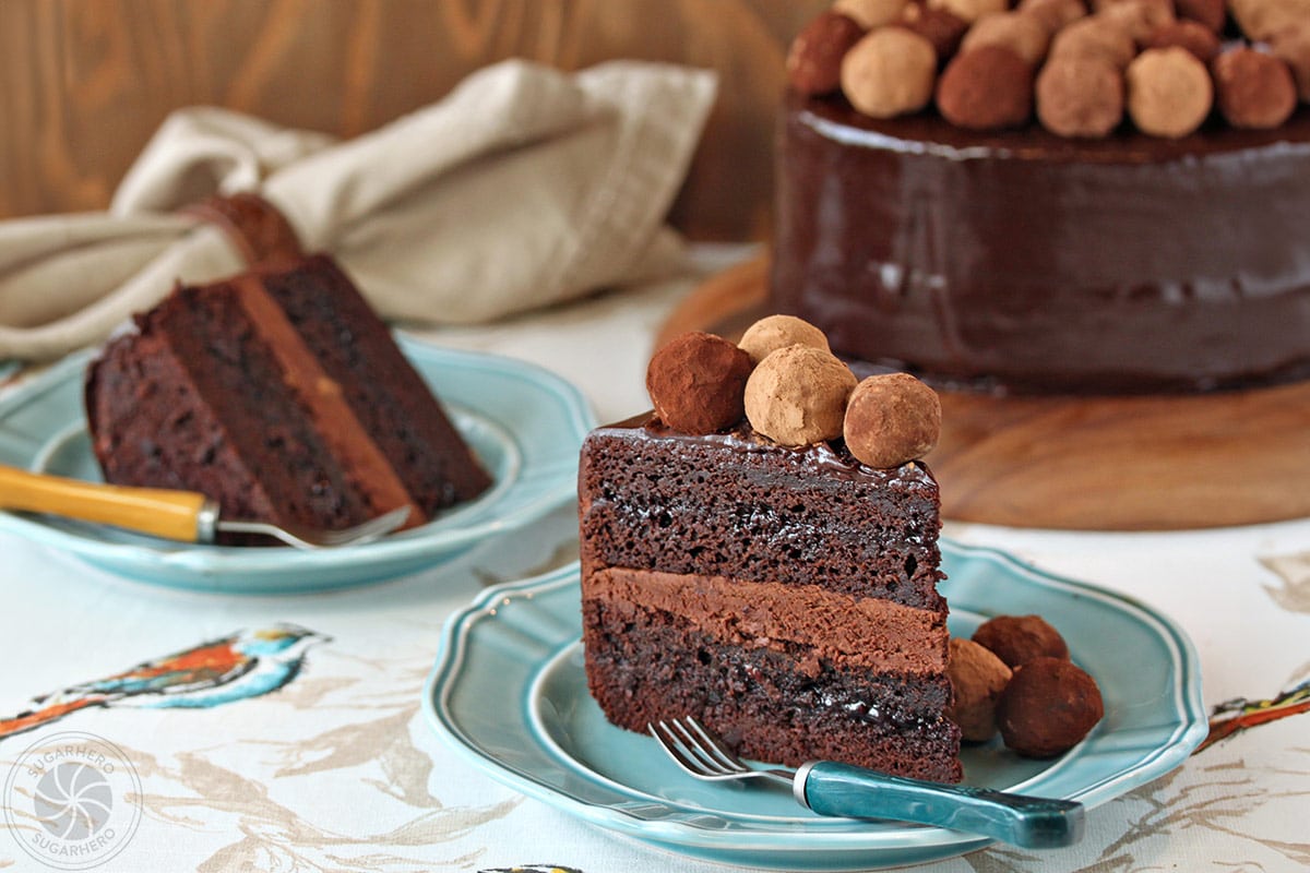 Truffle-Topped Heart Cake - Two slices of chocolate layered cake with chocolate filling showing. | From SugarHero.com 