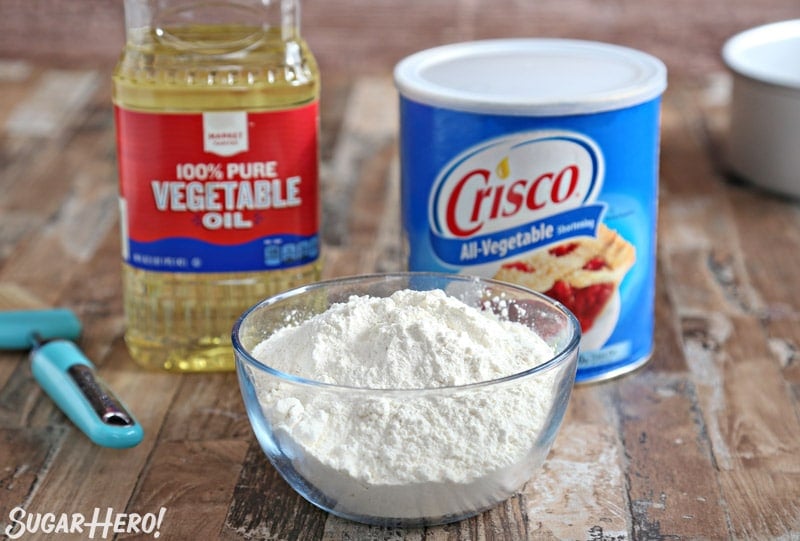 Homemade Pan Release - also known as "Cake Goop," this magical mixture is just what you need to get cakes out of pans cleanly and easily. Mix up a batch and you'll never have a broken cake again! | From SugarHero.com Picture of pan release ingredients: vegetable oil, flour, and vegetable shortening