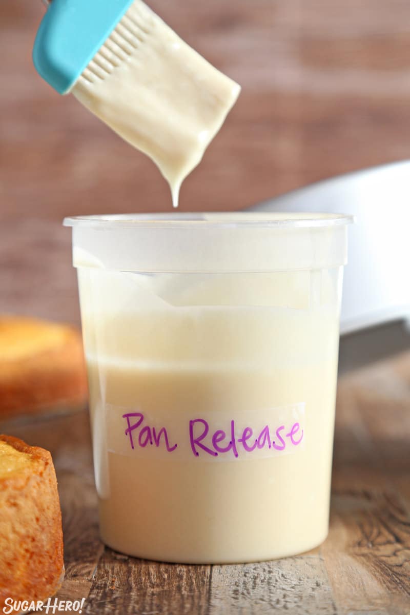 Homemade Pan Release - also known as "Cake Goop," this magical mixture is just what you need to get cakes out of pans cleanly and easily. Mix up a batch and you'll never have a broken cake again! | From SugarHero.com Dipping a teal pastry brush into homemade pan release