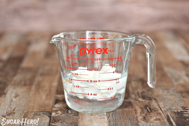 Shortening floating in water in a glass 2-cup measuring cup