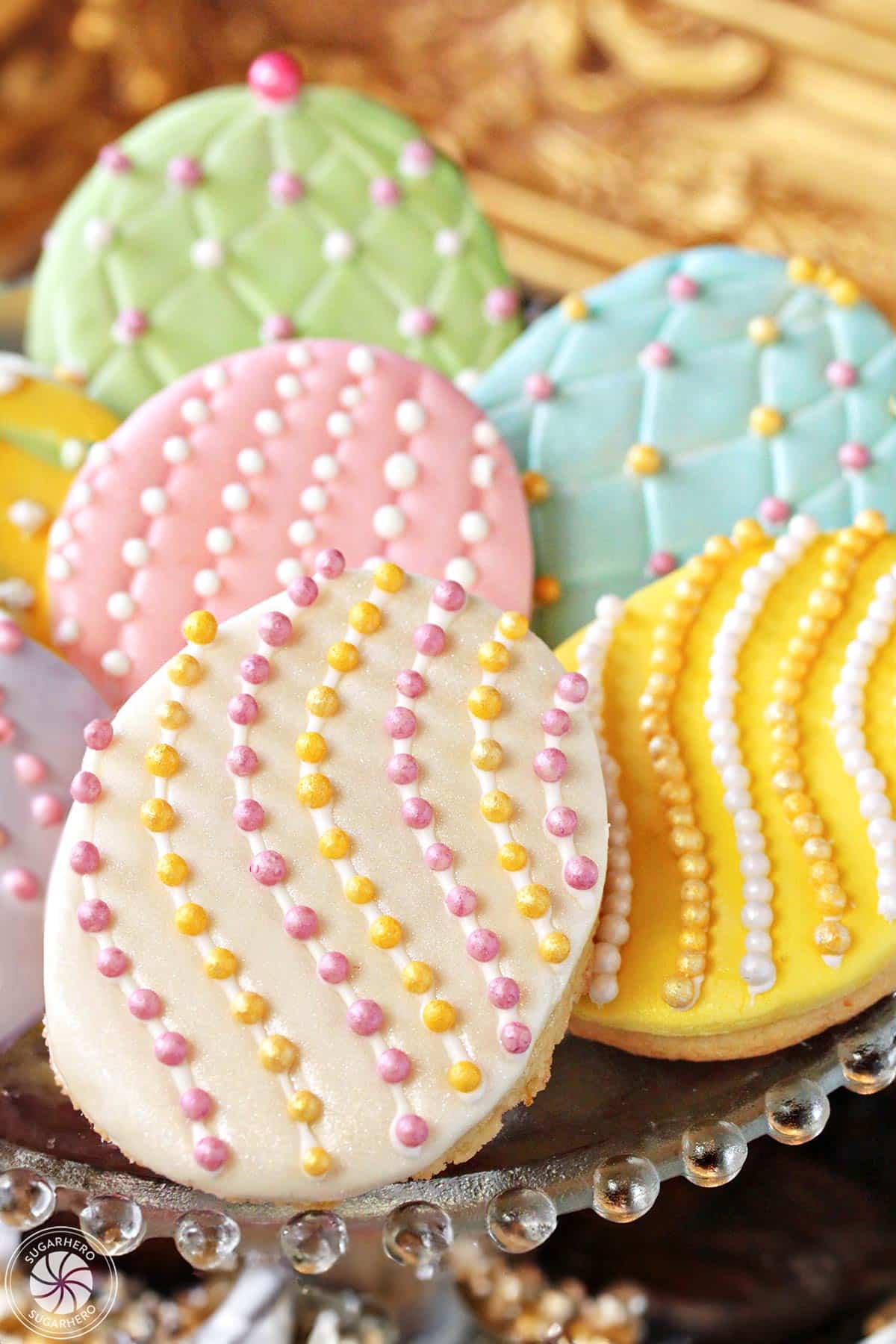 Stack of Easter egg sugar cookies with colorful sugar pearls and fondant decorations