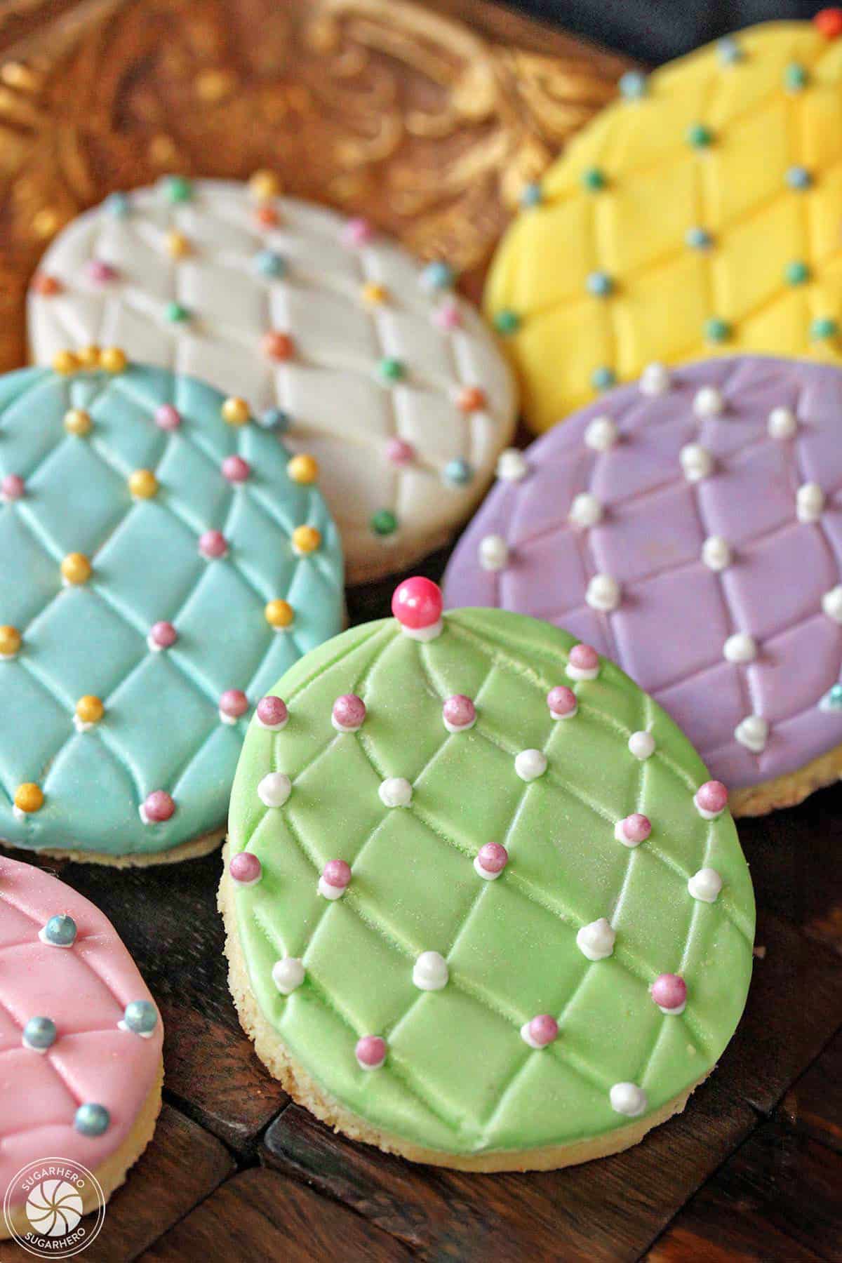 Three Easter egg sugar cookies on a gold tray 