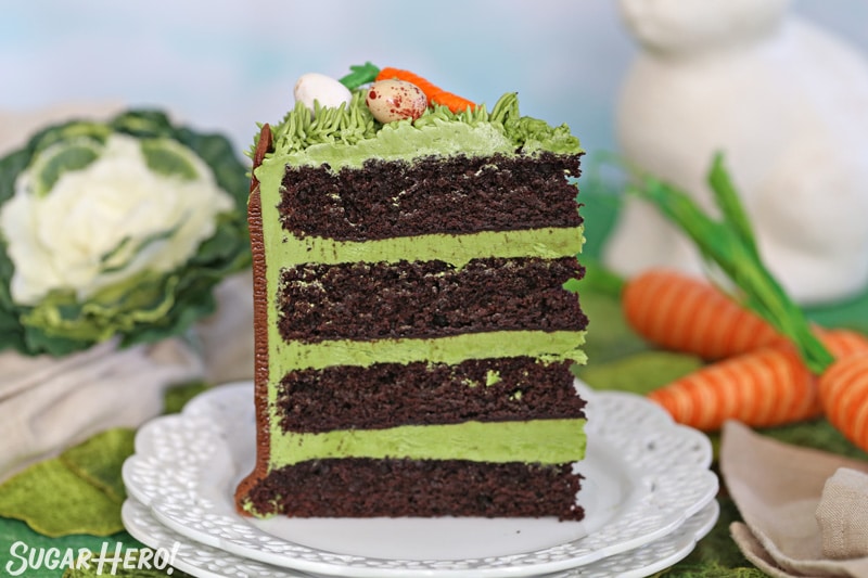 A single slice of Chocolate Easter Bunny Cake, with green frosting in between each chocolate cake layer