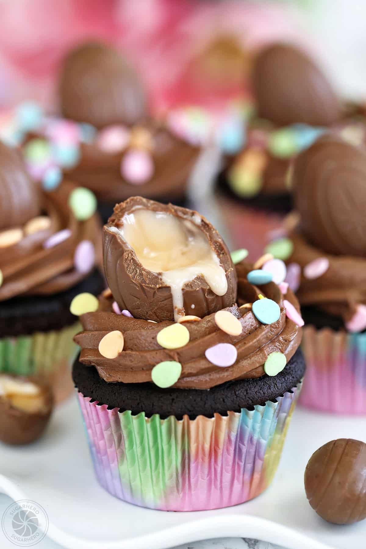 Chocolate cupcake with a creme-filled egg with a bite taken out of it