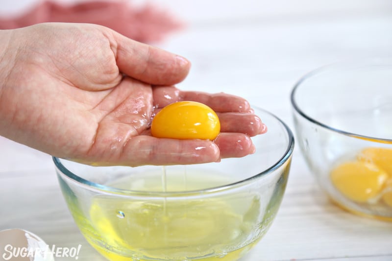 Separating eggs by pulling a yolk out of the whites by hand