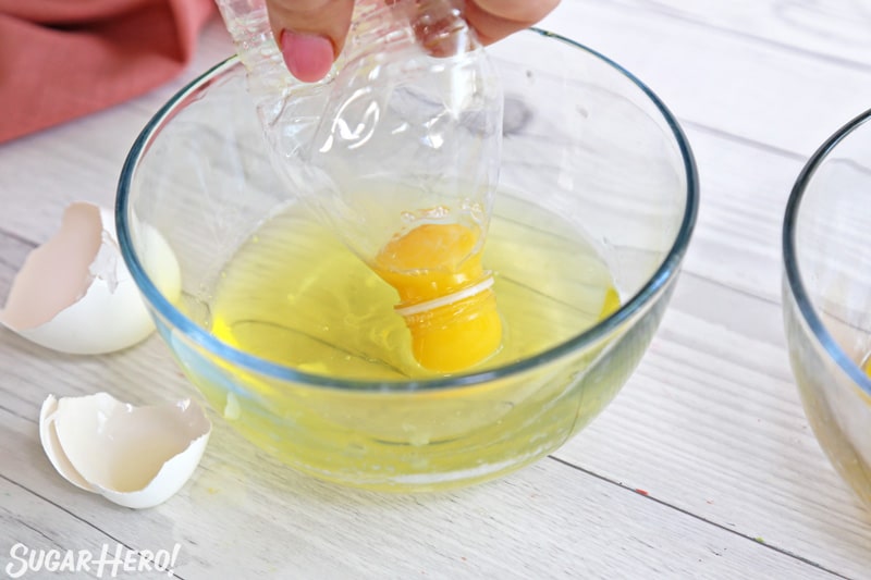Separating eggs using a plastic water bottle to suction the yolk out of the whites