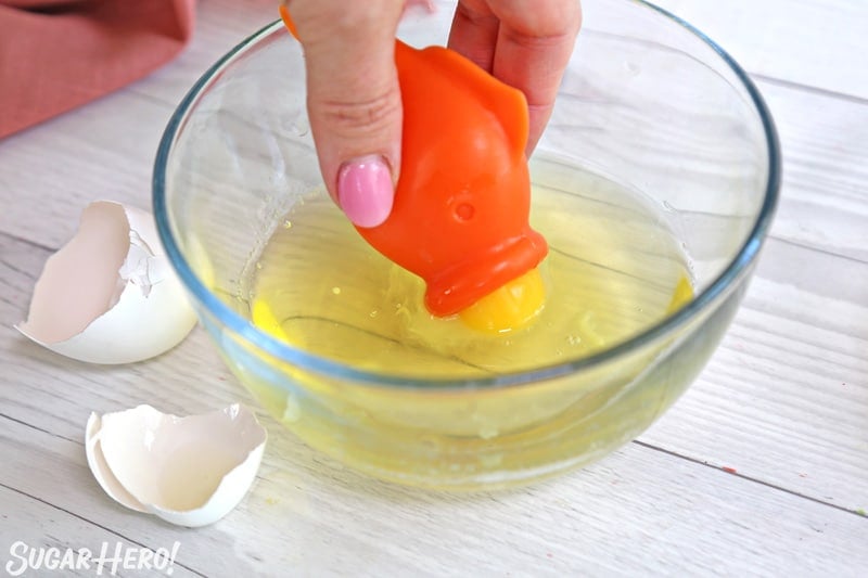 Separating eggs with an orange fish-shaped silicone egg separator