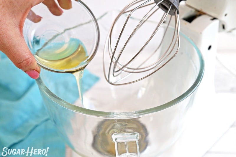 How to Make Meringue Cookies - crispy, crunchy egg white cookies that are fat-free and easy to make! | From SugarHero.com Adding egg whites to glass mixing bowl with whisk attachment
