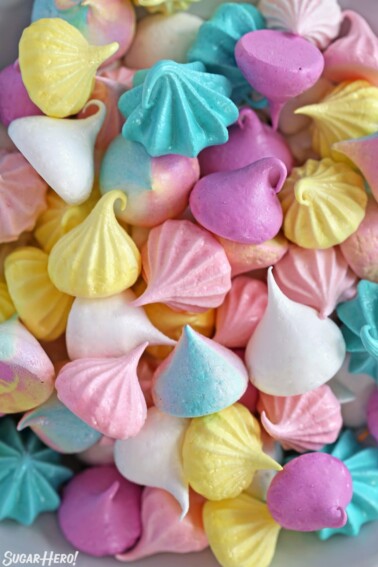 Colorful meringue cookies jumbled together on a plate.