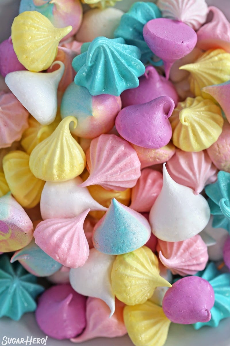 Overhead shot of colorful meringue cookies jumbled together on a plate