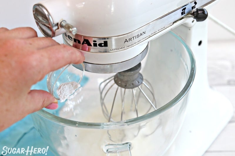 How to Make Meringue Cookies - crispy, crunchy egg white cookies that are fat-free and easy to make! | From SugarHero.com Adding cream of tartar to meringue mixture in glass mixing bowl
