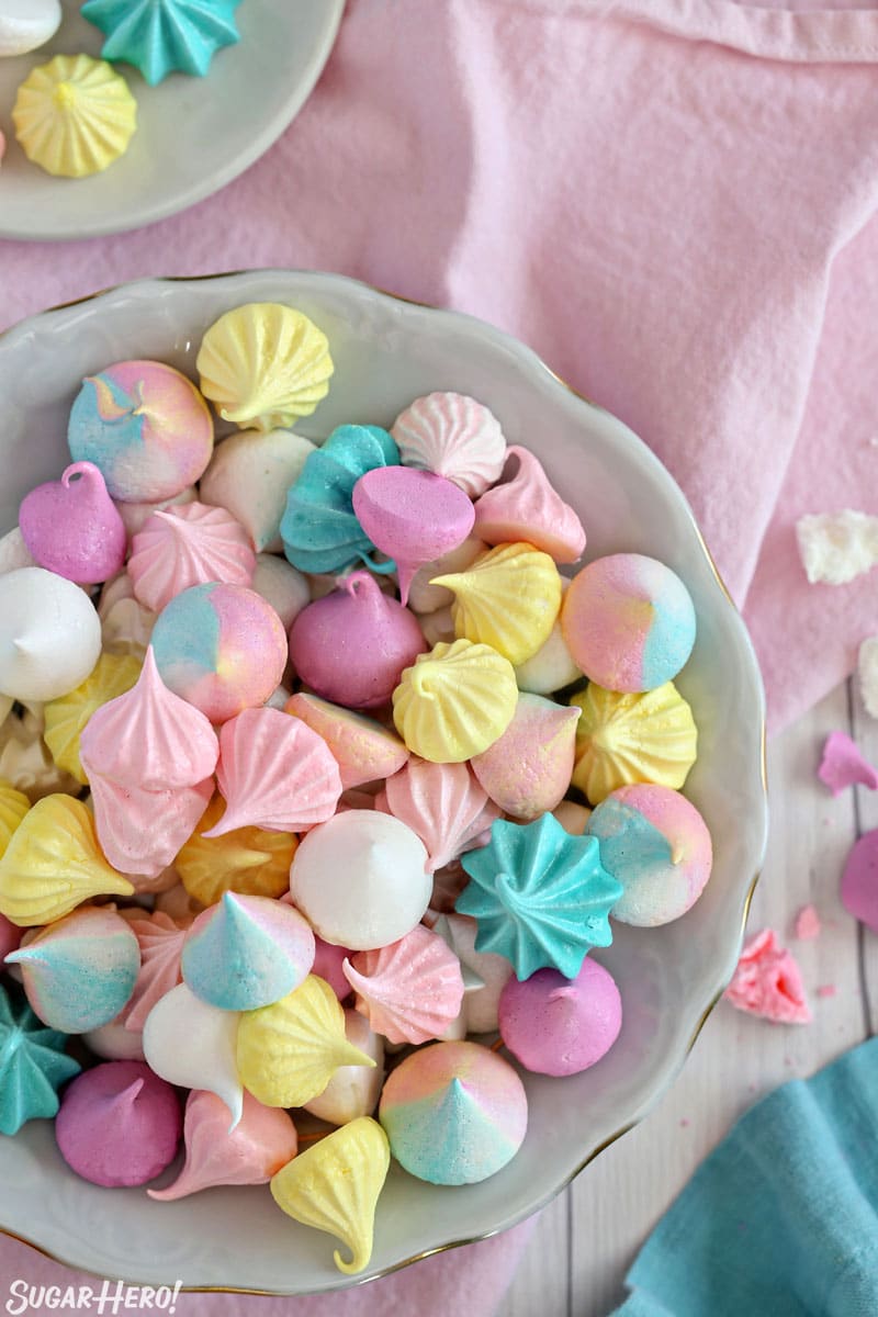 Overhead shot of colorful meringue cookies piled together in a large bowl