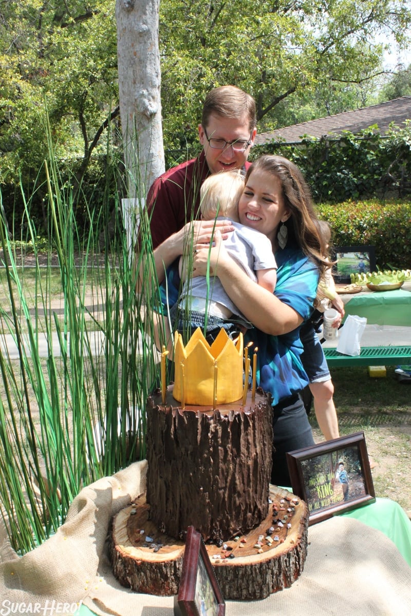 Where the Wild Things Are Birthday Cake is a beautiful nine layer cake! It has a layer of chocolate cake, sandwiching chocolate buttercream, salted caramel buttercream, and salted caramel filling. It is delicious and perfect for birthday parties! | From SugarHero.com Where the Wild Things Are Birthday Cake - Photo of Asher being hugged by Elizabeth. | From SugarHero.com